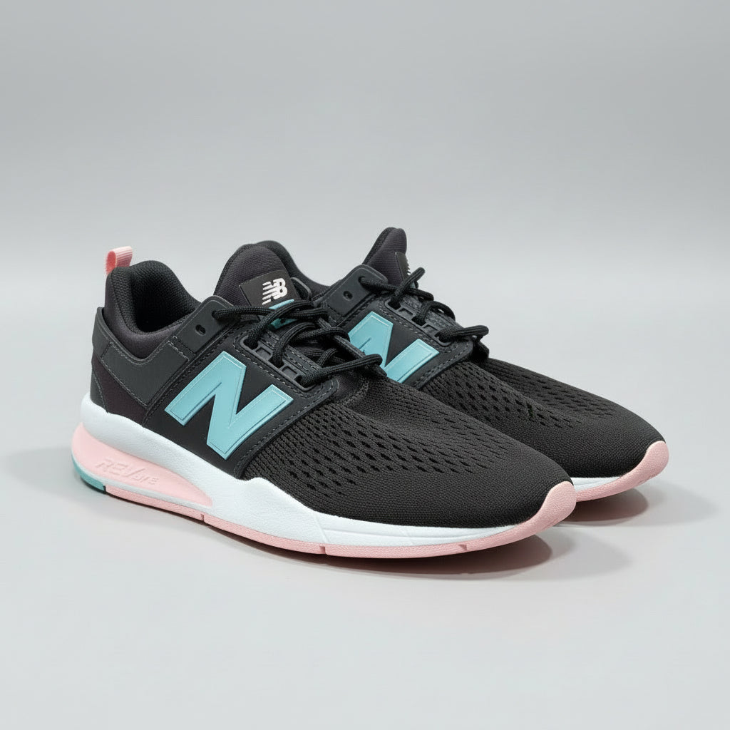 Black and pink sneaker with New Balance logo on a cardboard surface