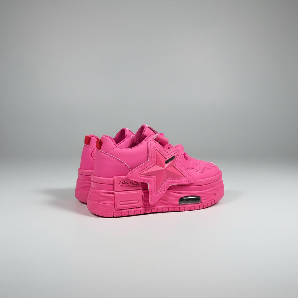 Pink sneaker with a star design on a beige surface