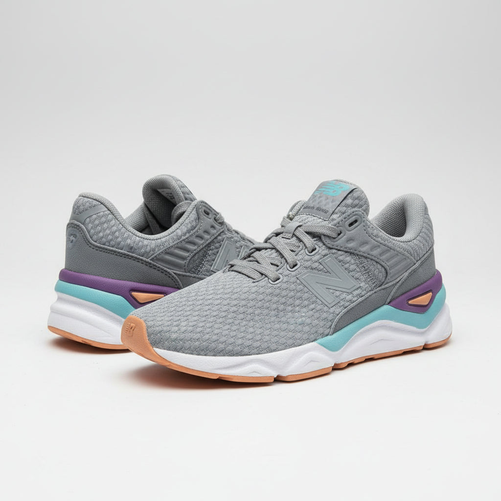 Gray sneakers with purple accents on a cardboard surface