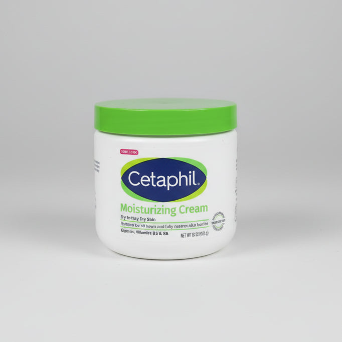 Cetaphil moisturizing cream jar on a cardboard box with a wooden surface underneath