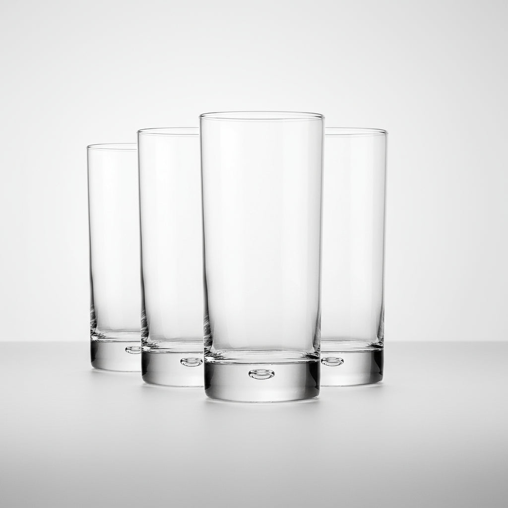 Set of four clear glass tumblers on a white background