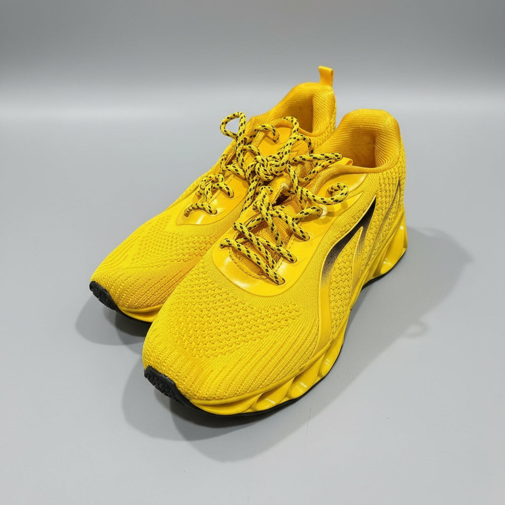 Yellow sneaker with gold laces on a gray floor