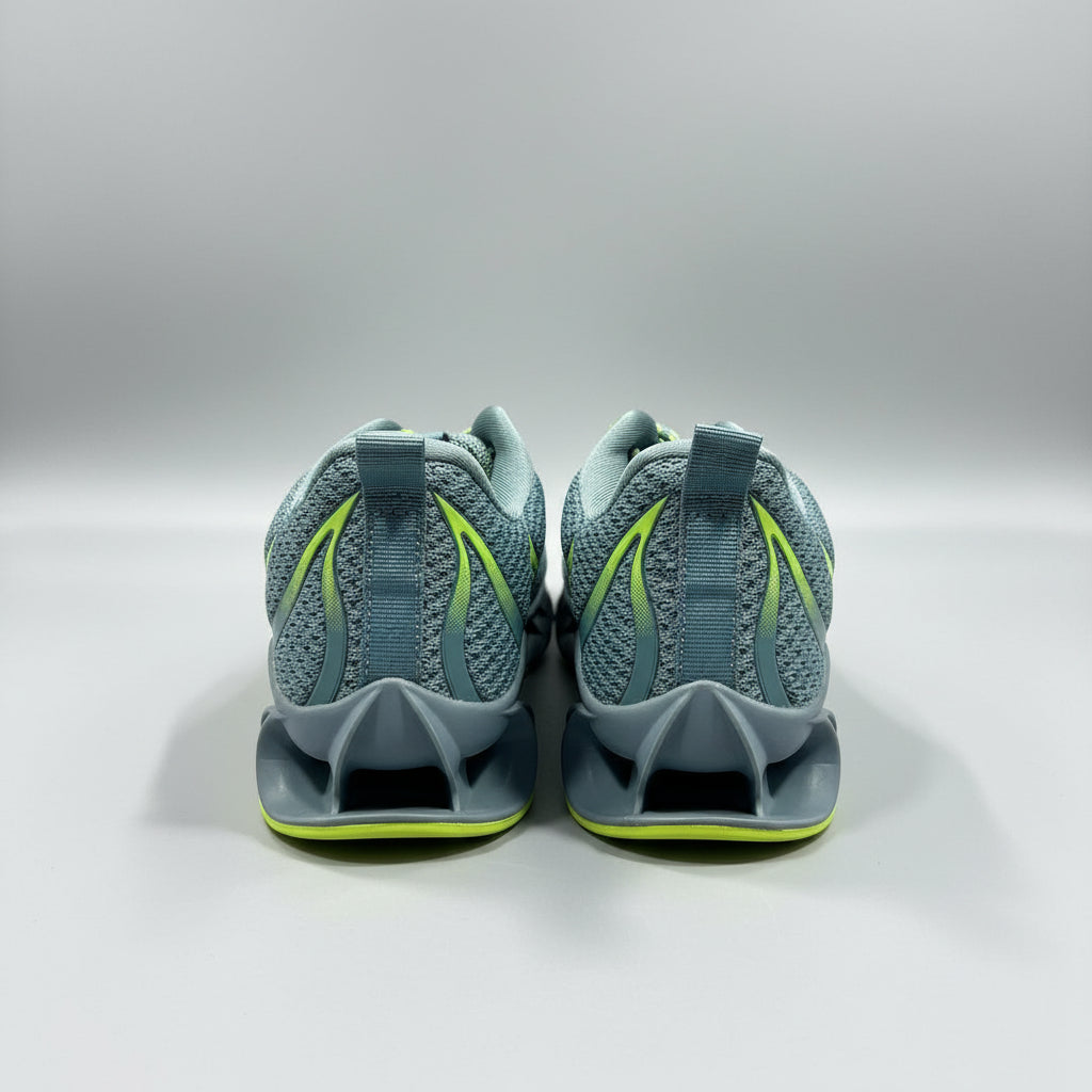 Pair of gray sandals with green accents on a gray surface