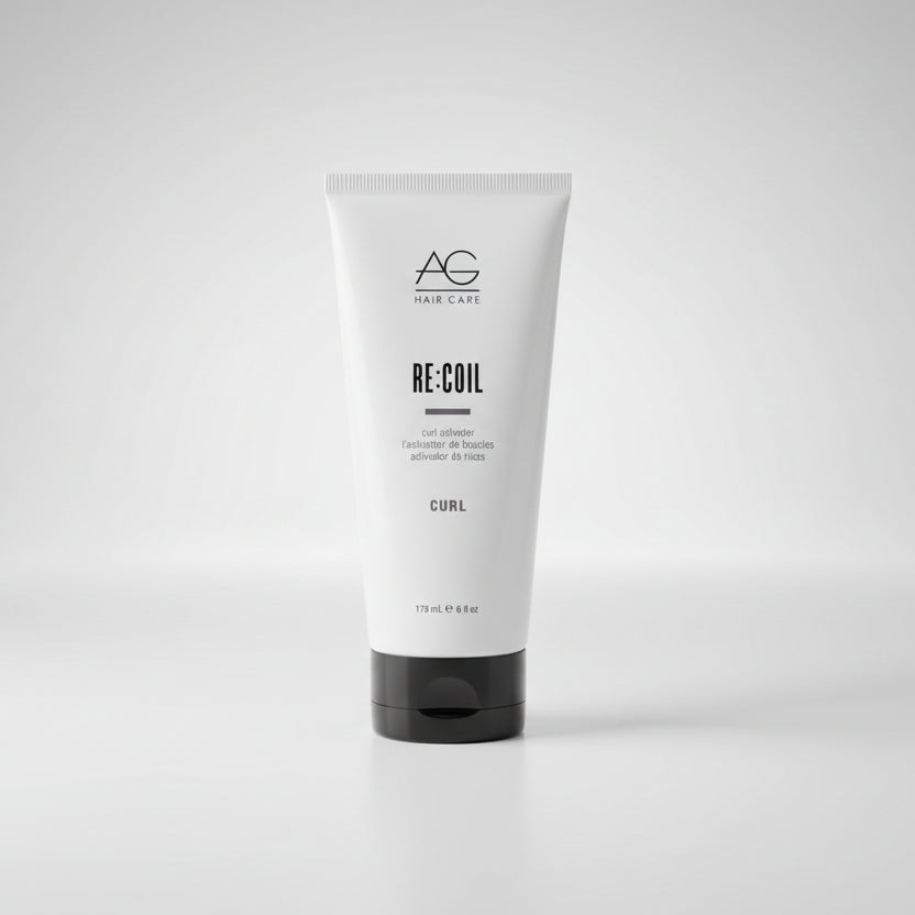 Tube of AG Hair product on a gray concrete surface