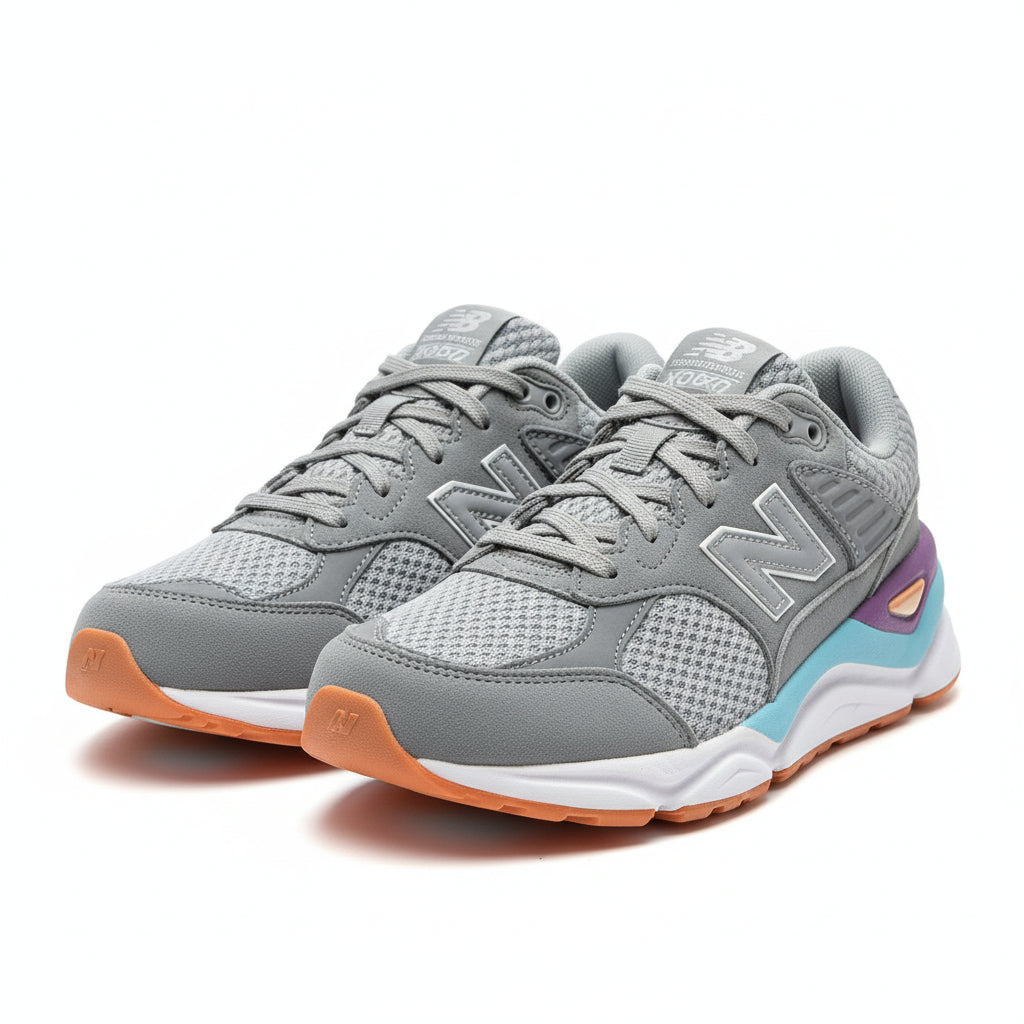 Gray sneakers with purple and blue accents on a cardboard surface