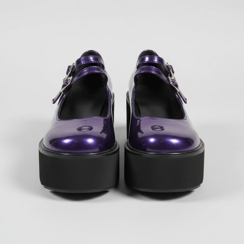 Purple and black shoes on a cardboard box with a blurred background