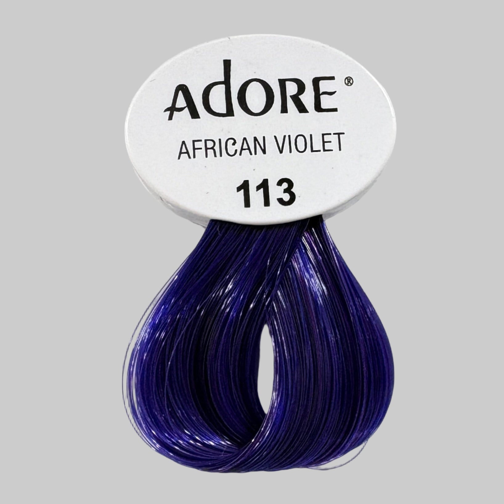Adore hair color packaging with 'African Violet' shade on a store shelf.