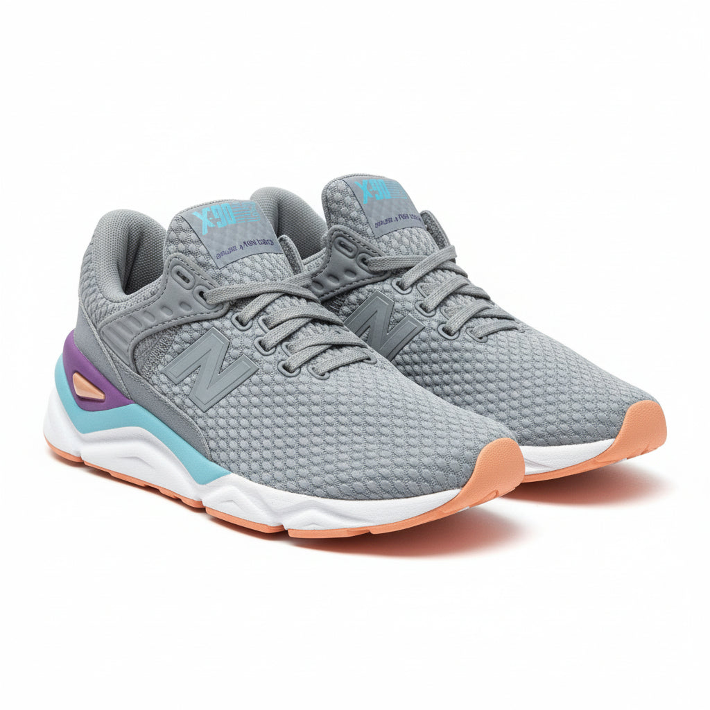 Gray sneakers with orange accents on a cardboard box