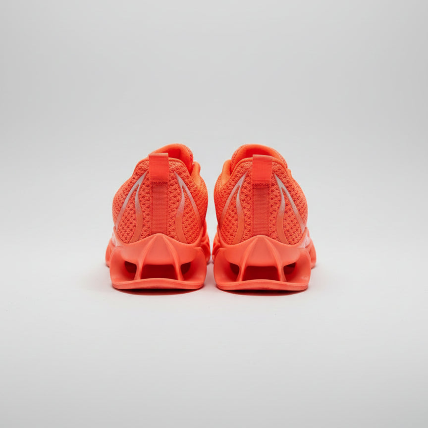 Pair of orange sandals on a dark surface