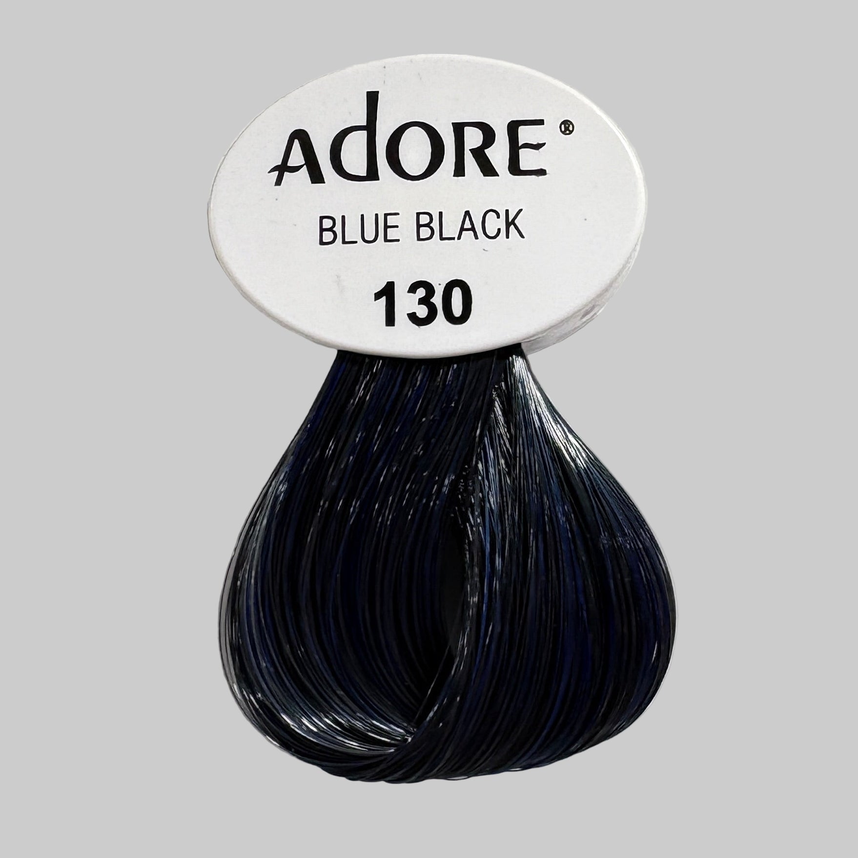 Adore Blue Black hair color bottle on a shelf with other hair color products.