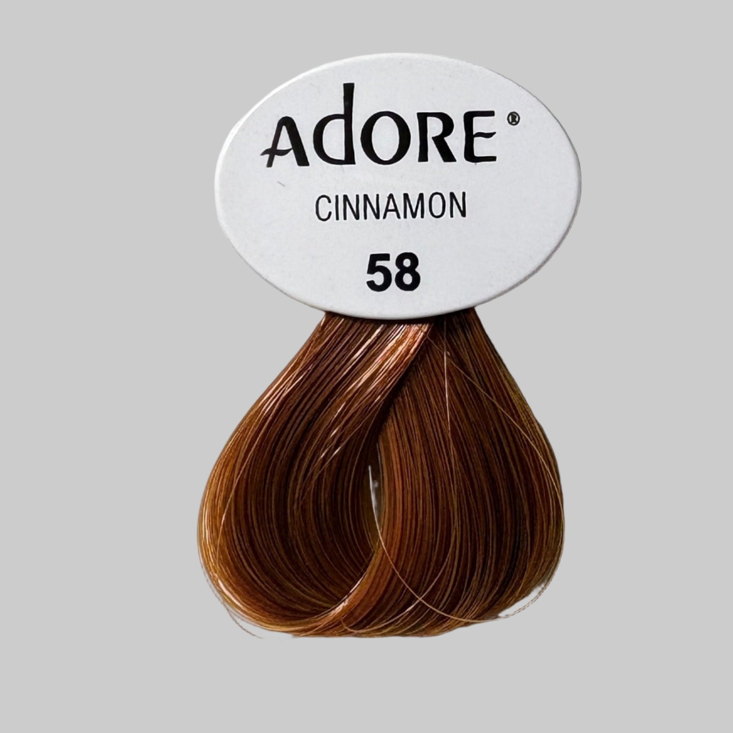 Adore hair color packaging with cinnamon shade on a store shelf.