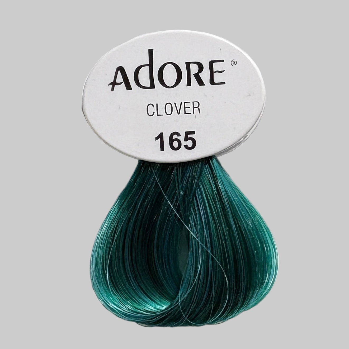 Display of hair dye products including Adore and Sevich on a shelf.