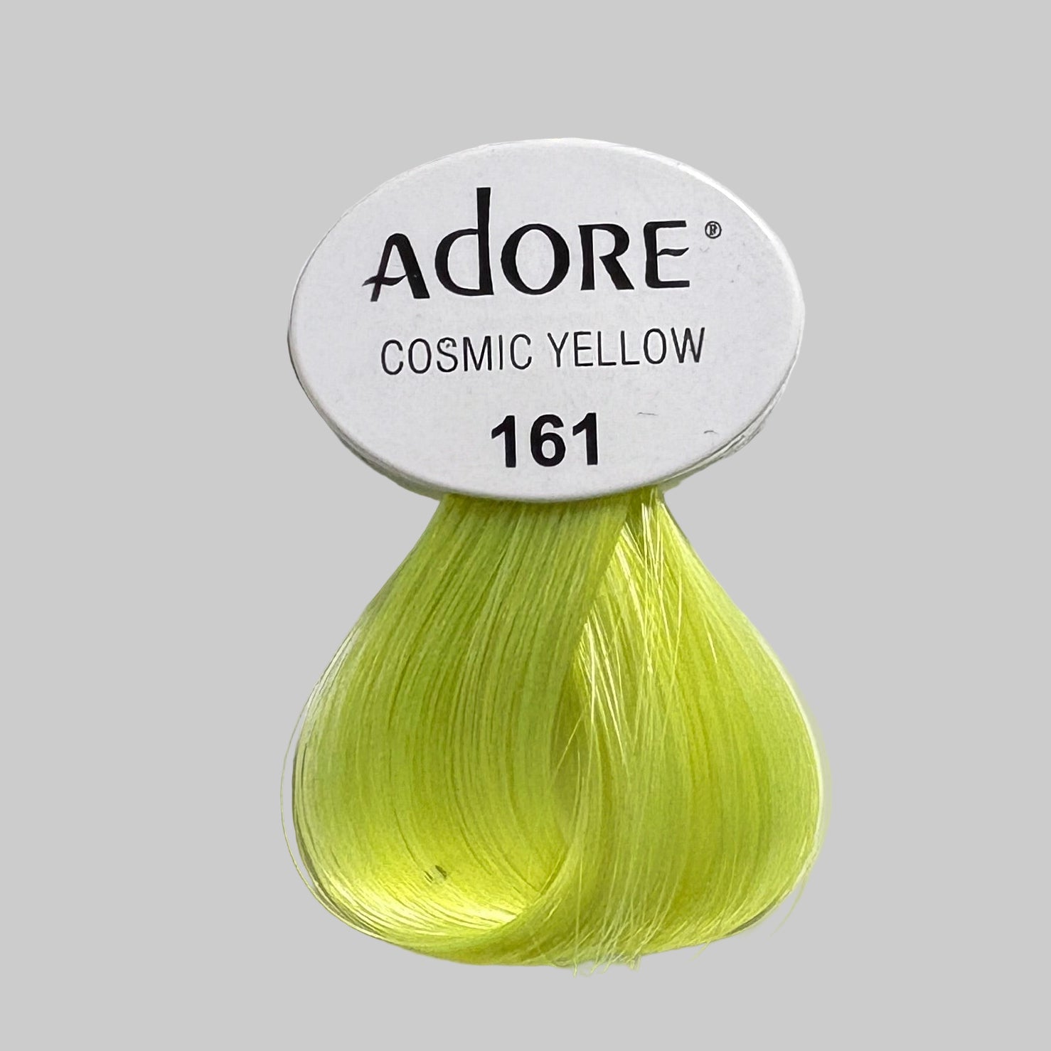 Adore hair color swatches with cosmic yellow shade on a display box.