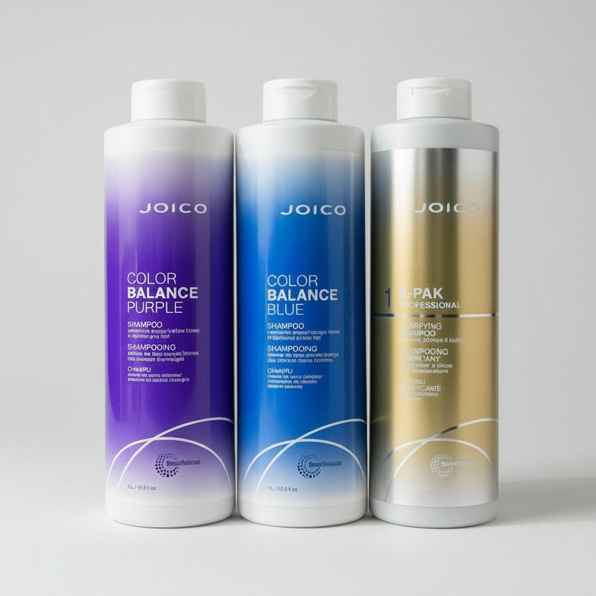 Three bottles of Joico Color Balance shampoo on a gray background