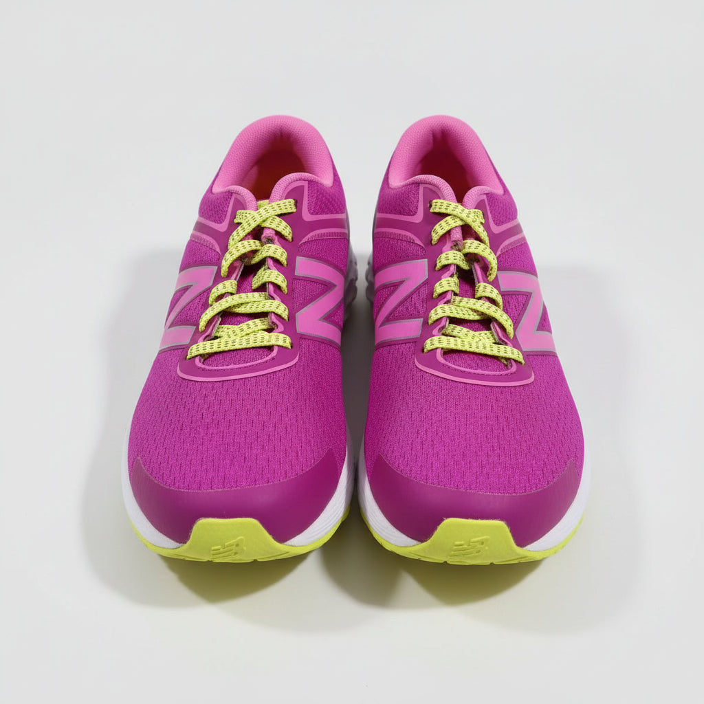Purple running shoes with yellow laces on a cardboard surface