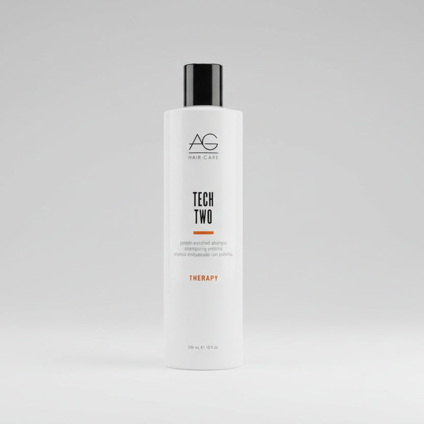 Bottle of AG Tech Two on a gray concrete surface