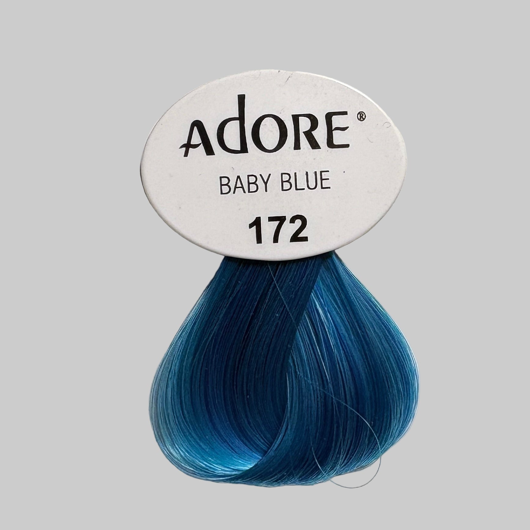 Adore hair color packaging with blue shade on a store shelf.