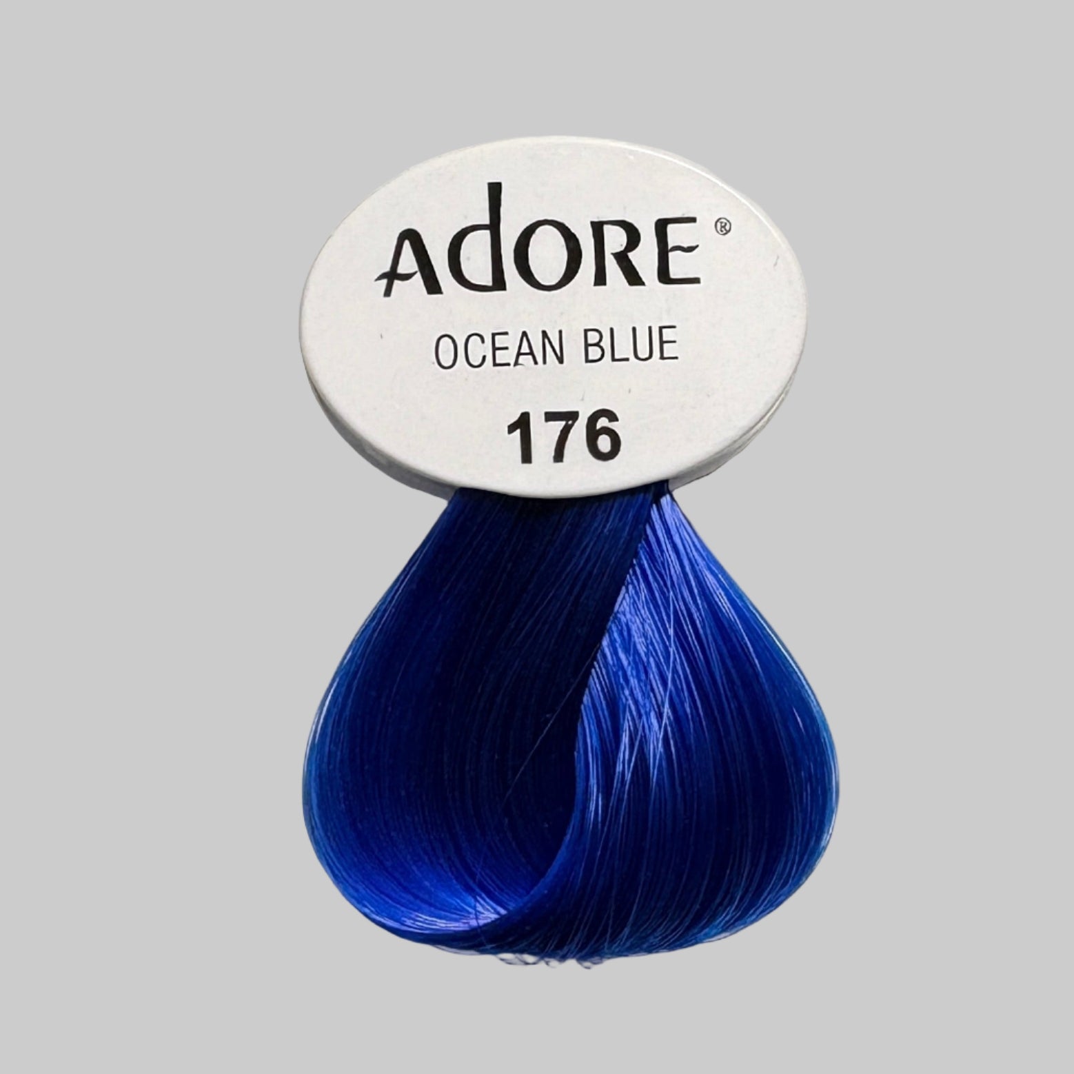 Adore Ocean Blue hair color packaging on a shelf with other hair color products.