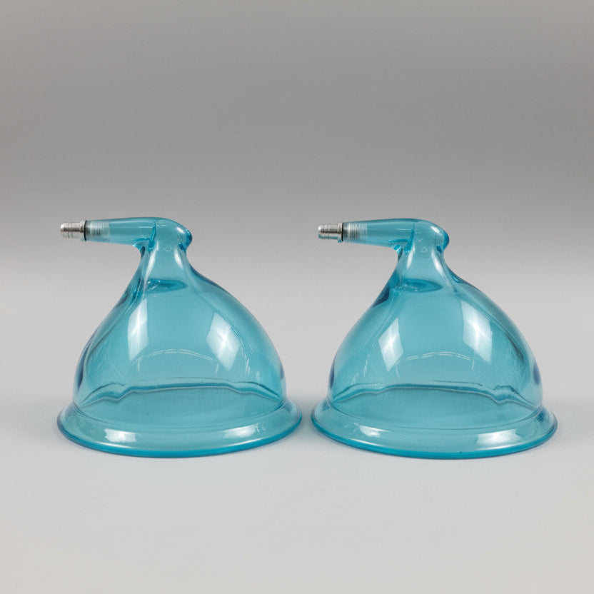 Two blue plastic cones with nozzles on a gray background