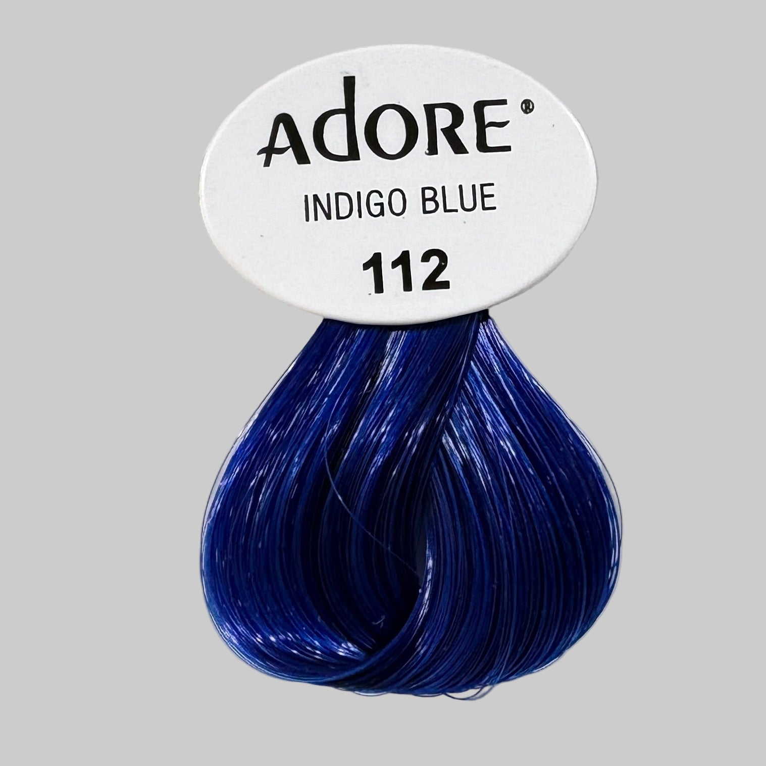 Adore hair color packaging with Indigo Blue shade on a store shelf.