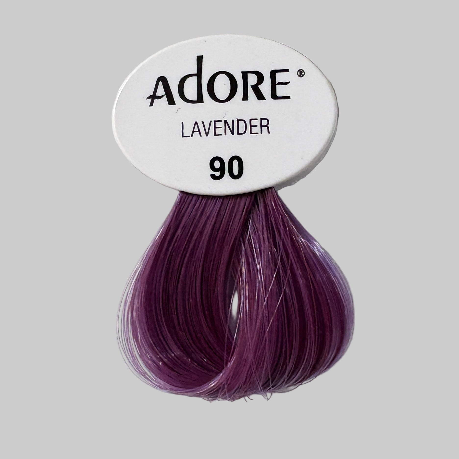 Adore hair color package with purple hair strands on a store shelf.