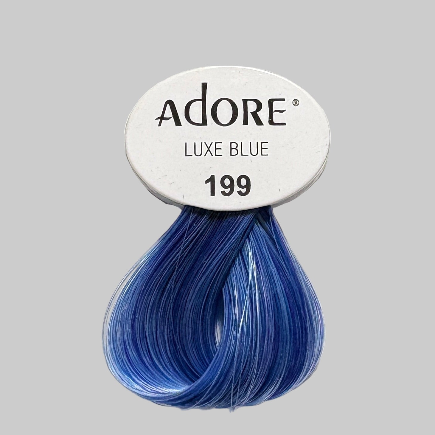 Adore hair color products displayed on a shelf with other beauty items.