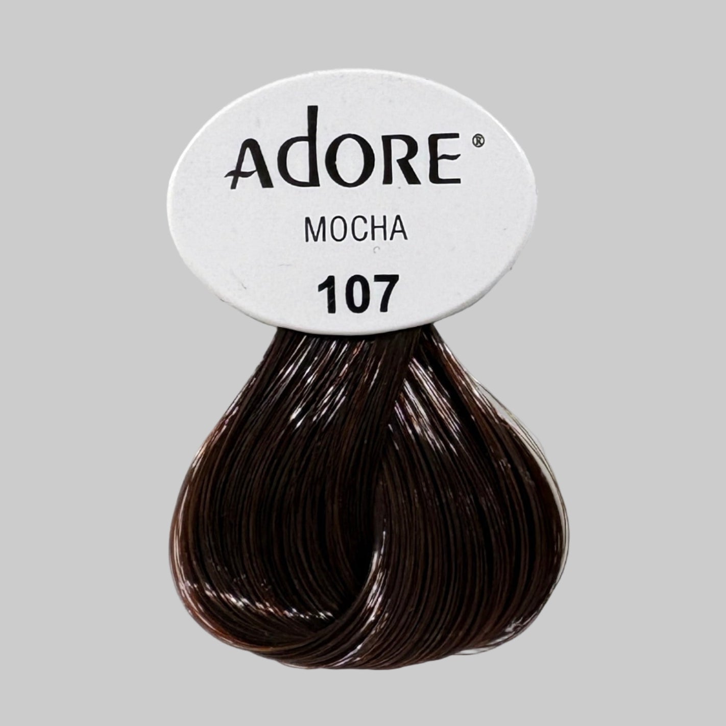 Adore hair color boxes on a store shelf with visible branding.