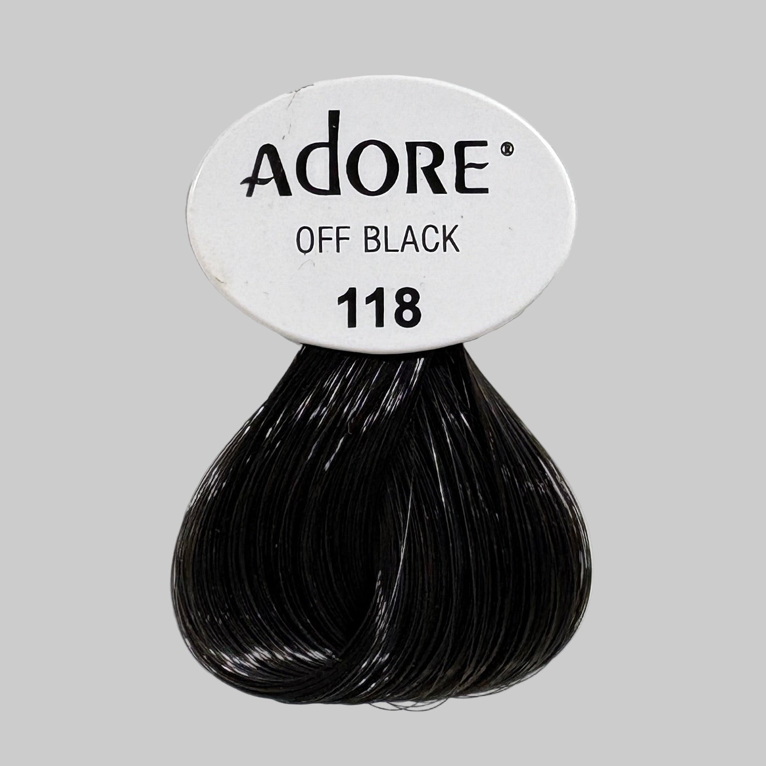 Adore hair color packages on a shelf with other products.