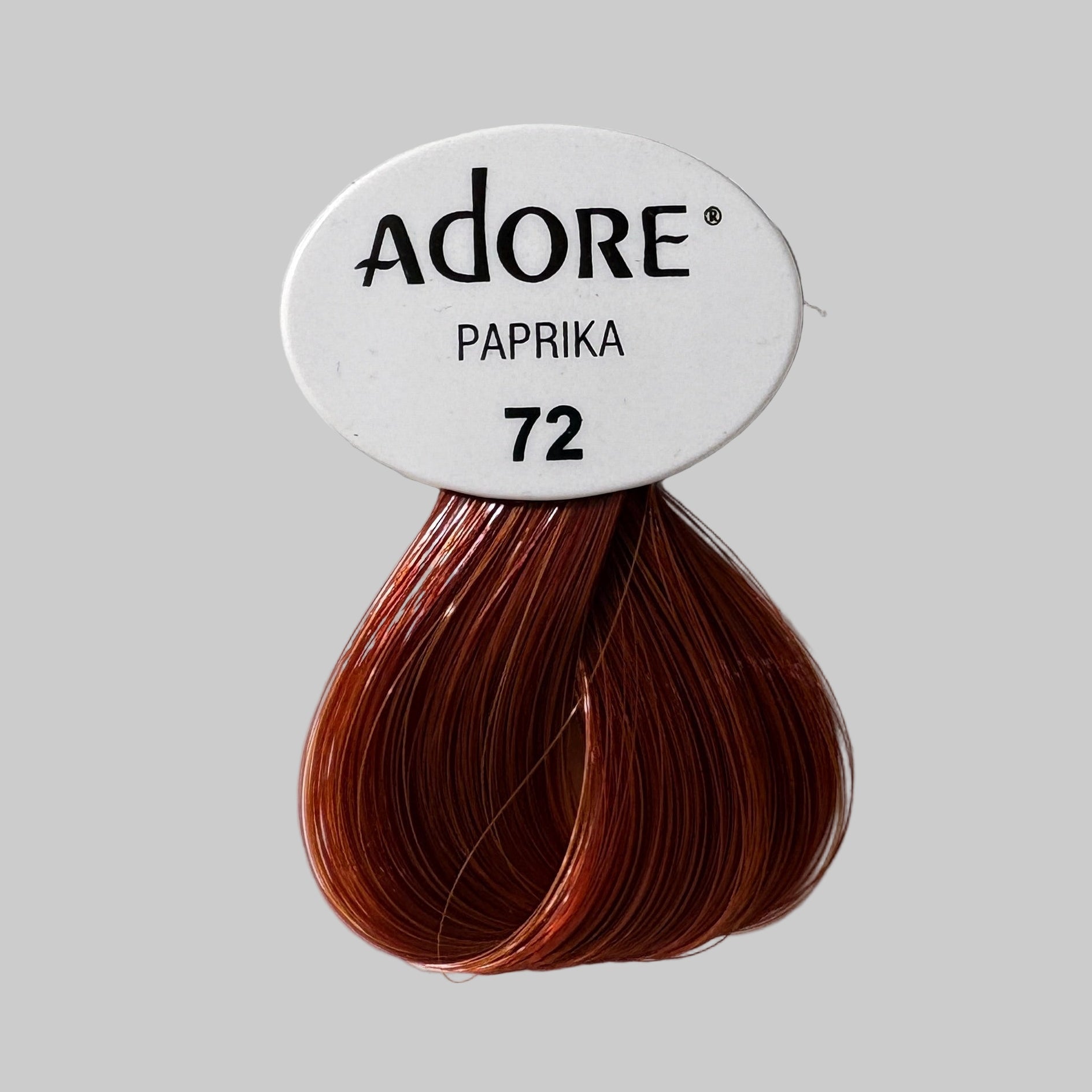 Adore Paprika 72 hair color packaging with a red hair color swatch on a white background.