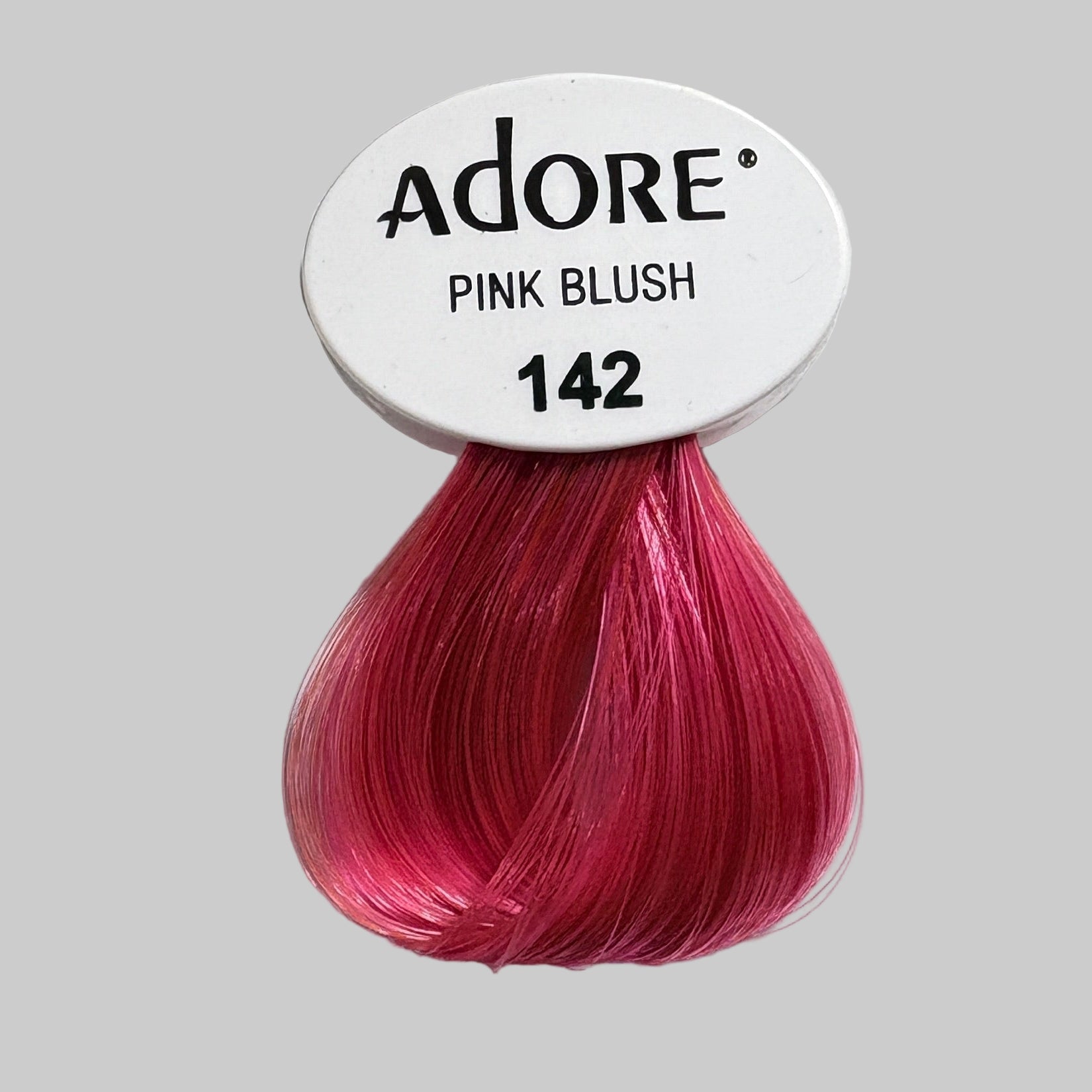 Adore Pink Blush hair color pack on a shelf with other hair color products.