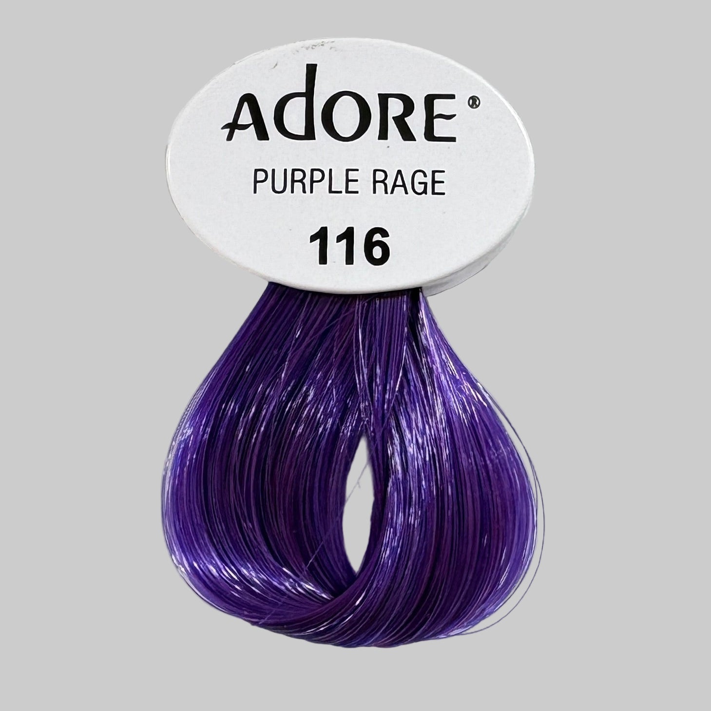 Adore Purple Rage hair color packaging with a purple sample on a shelf.