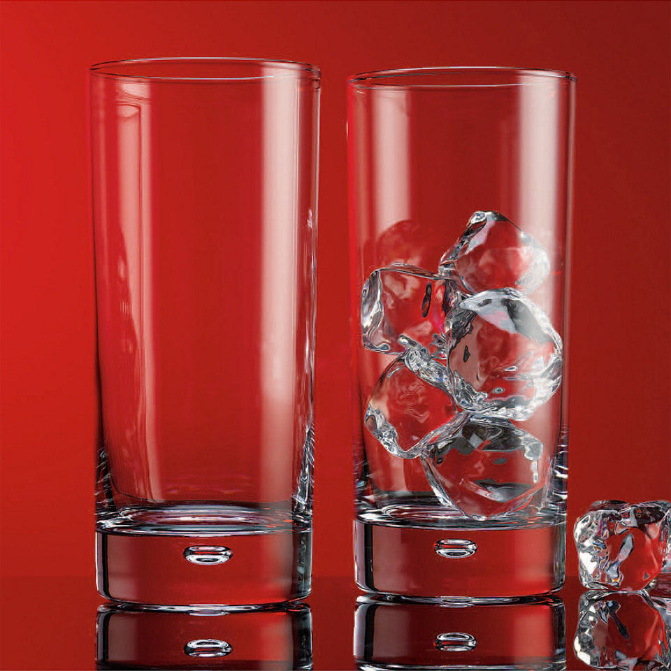Two clear glasses with engraved designs on a red background