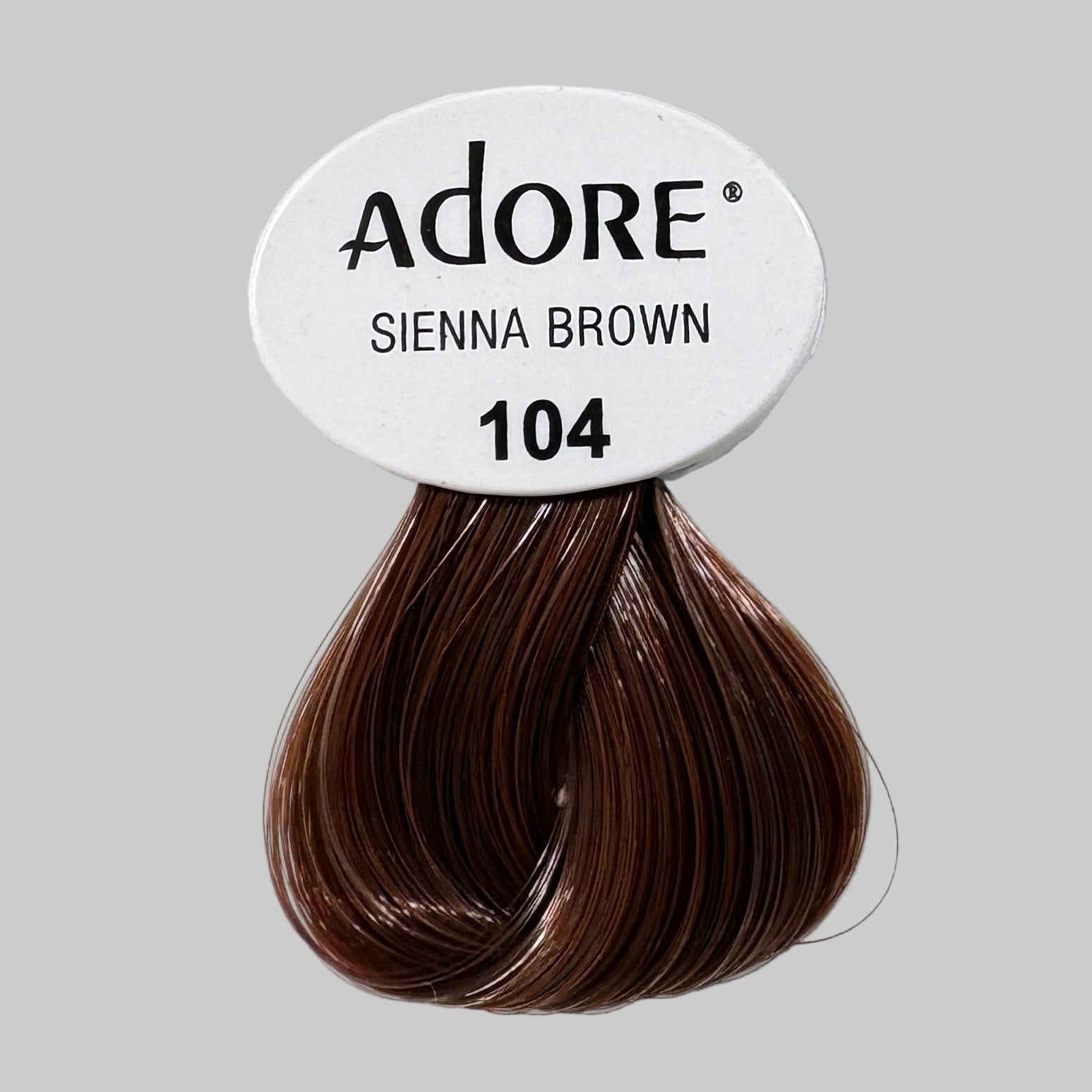 Adore hair color packaging with Sienna Brown shade on a store shelf.