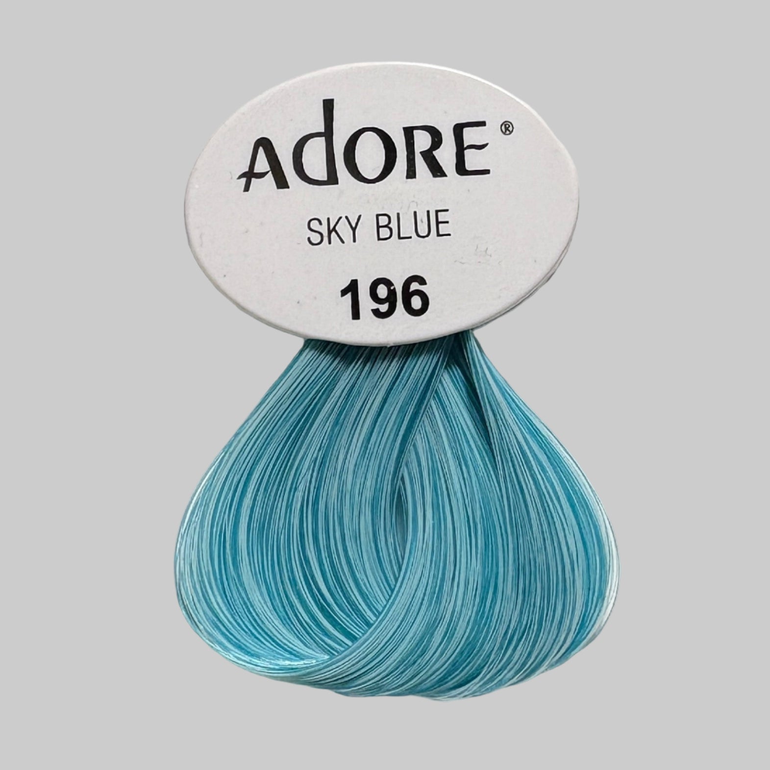 Adore Sky Blue hair color packaging with a close-up of the product.