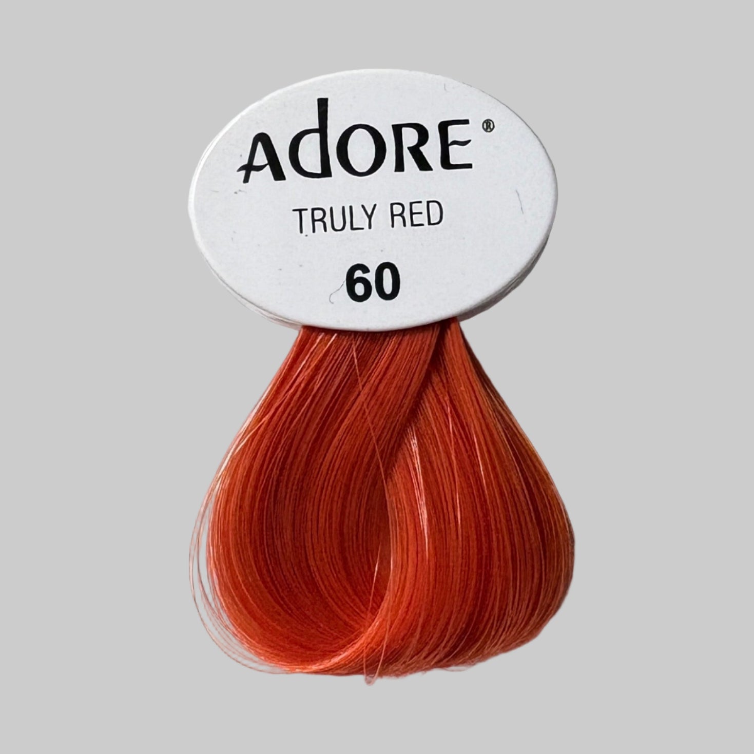 Display of Adore hair color products with visible branding and product names.