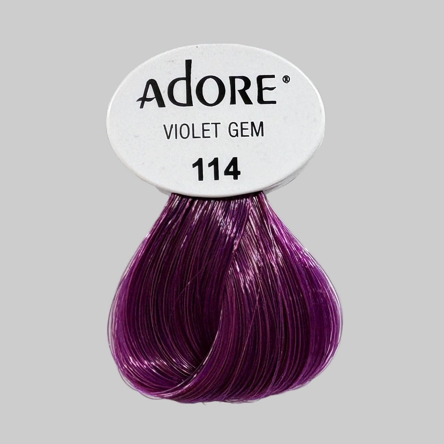 Adore Violet Gem hair color packaging with purple swatch on a shelf.
