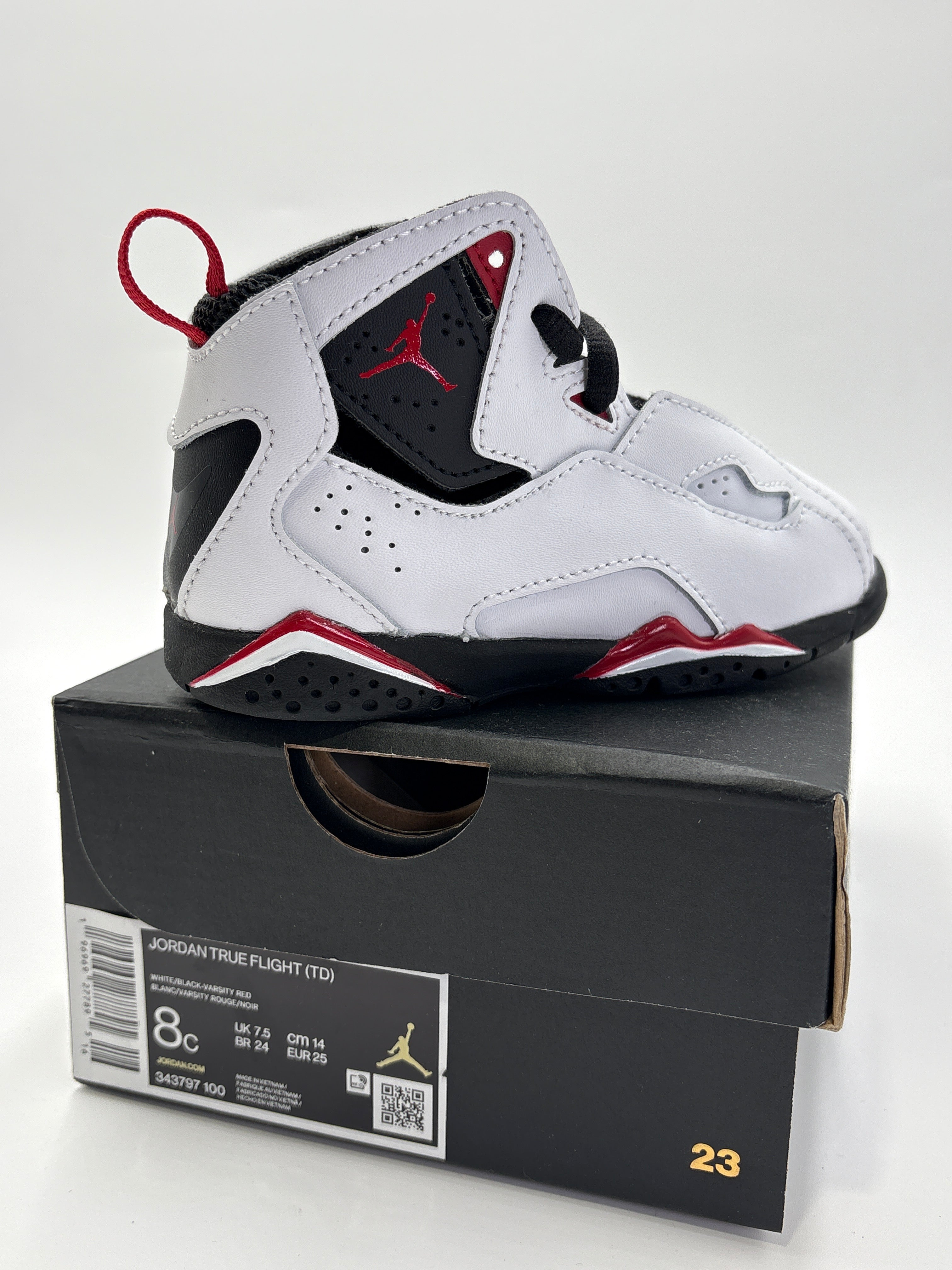 Jordan True Flight toddler shoes in white black and red on top of black shoe box