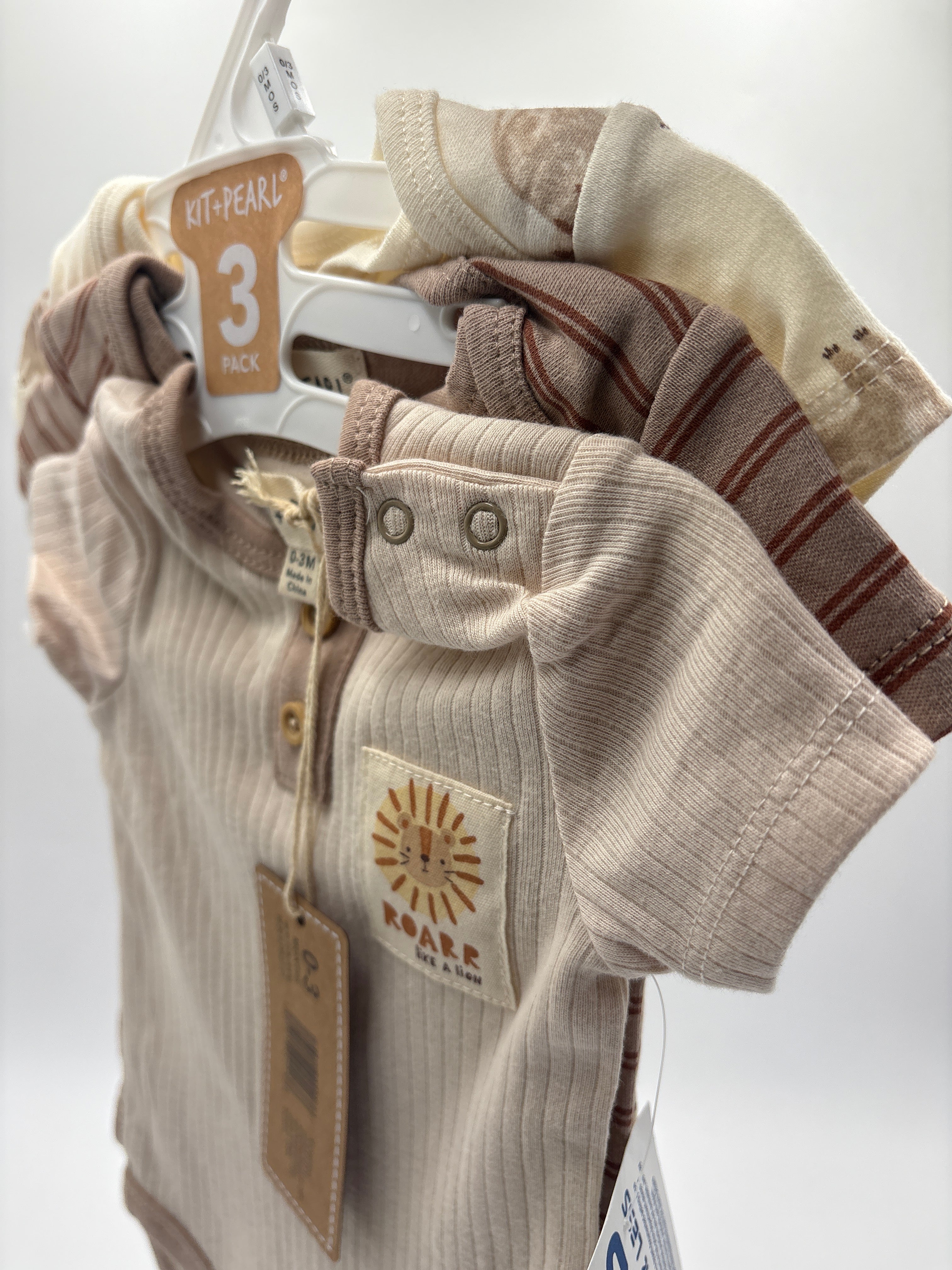 Neutral tones baby romper set 3 pack with striped and solid designs on hangers