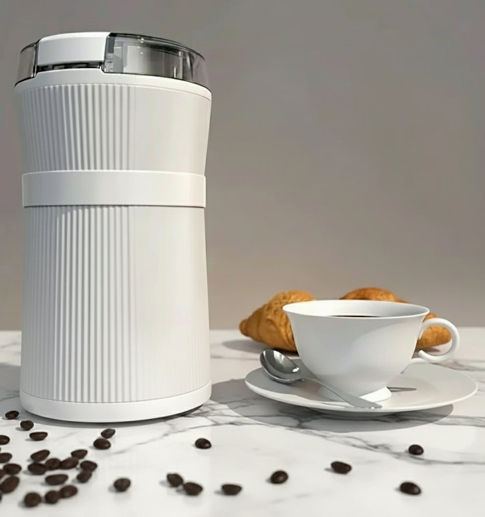 White coffee grinder on a wooden surface with a cup of coffee and pastries, accompanied by text 'Become a Home Barista'.